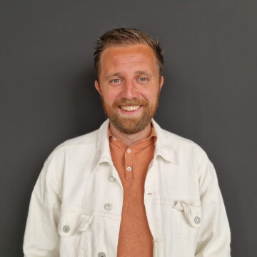 Accountmanager Mark Rijkeboer voor grijze muur